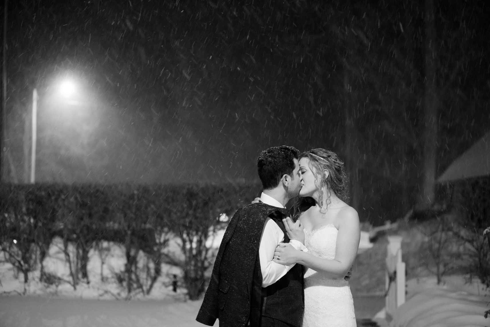 winter wedding snowflakes couple kissing at the end of the night Highlands Country Club