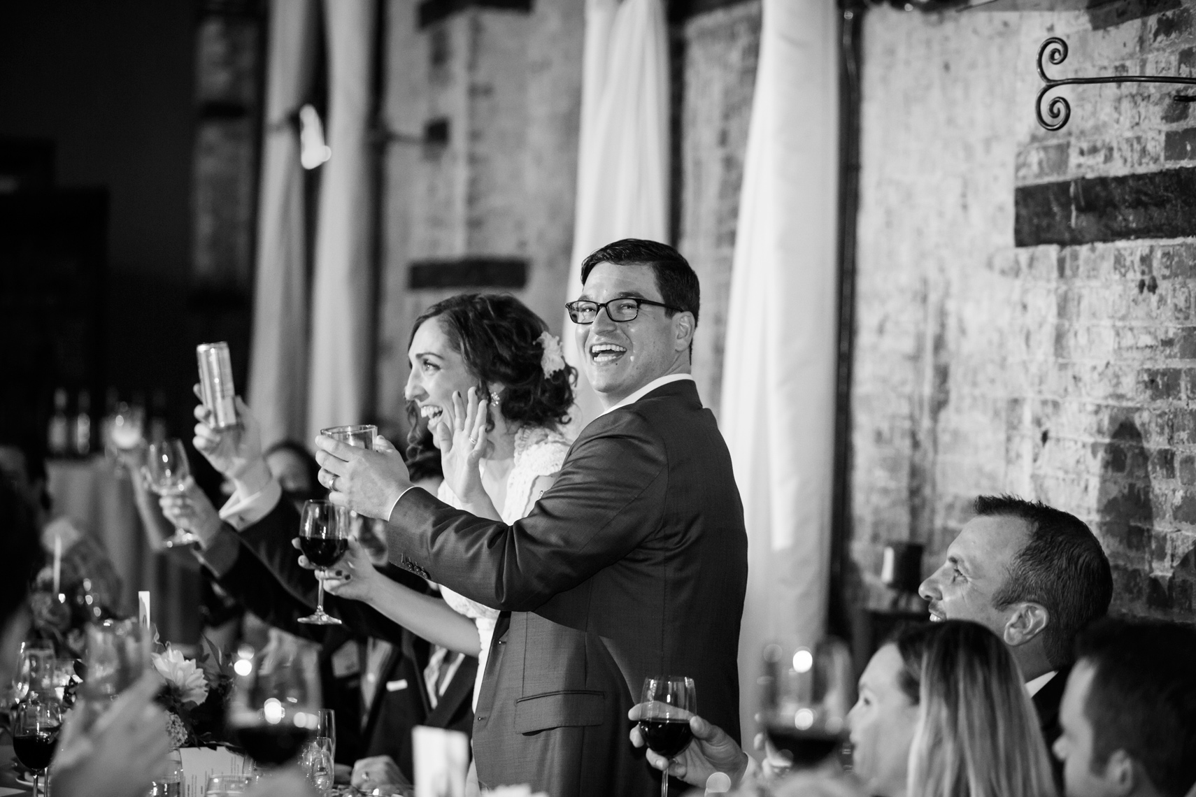 couple laughing during the toasts at their wedding The Green Building Brooklyn