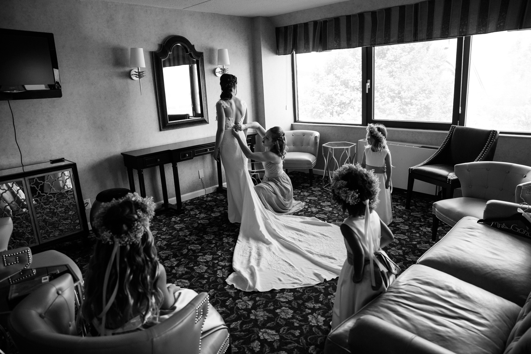 bride getting ready for her wedding at hotel with her bridesmaids